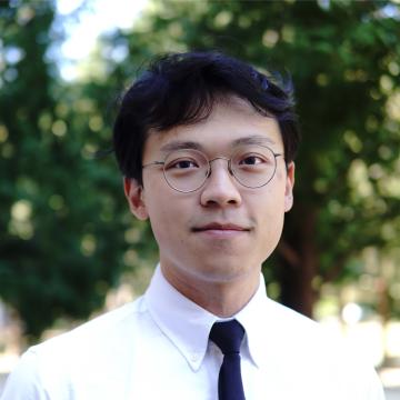Image of a man smiling with glasses